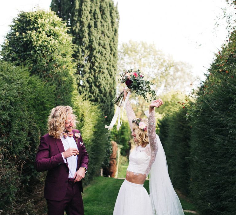 Happy Bride in Separates and Flower Crown and Groom in Burgundy Suit