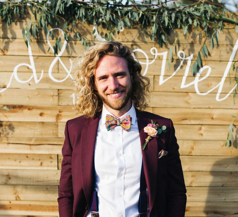 Groom in Burgundy Paul Smith Suit and Floral Bow Tie