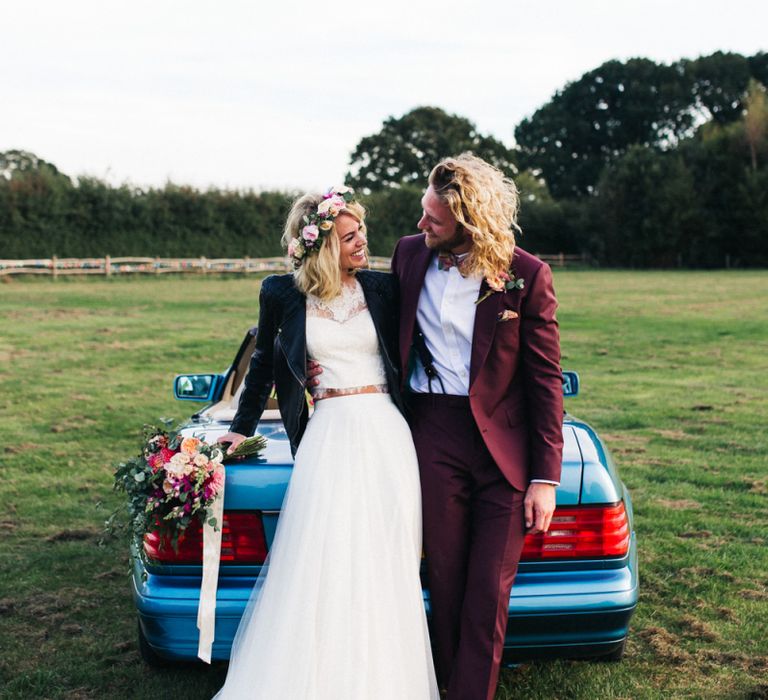 Cool Bride and Groom Hanging Out By Their Wedding Car