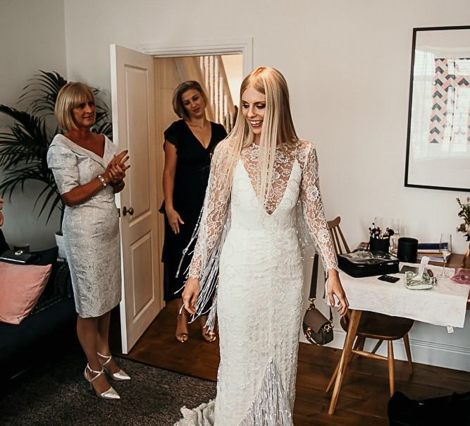 Bride wearing a lace dress with beaded tassels