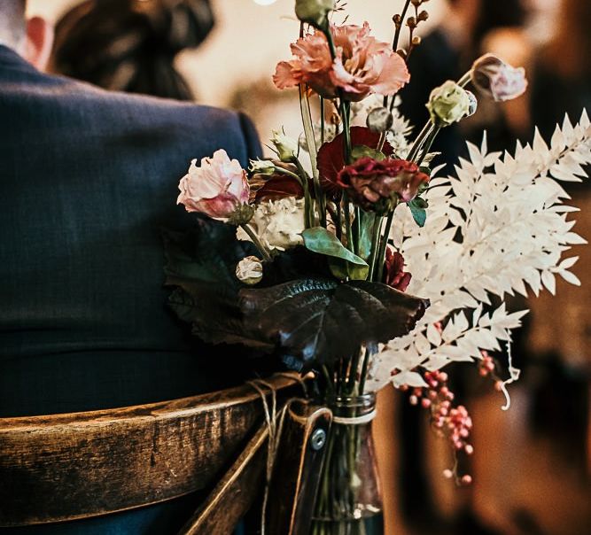 Pink flower and foliage chair decor at Clapton Country Club wedding