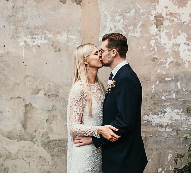 Bride and groom embrace at contemporary celebration with botanical styling in London