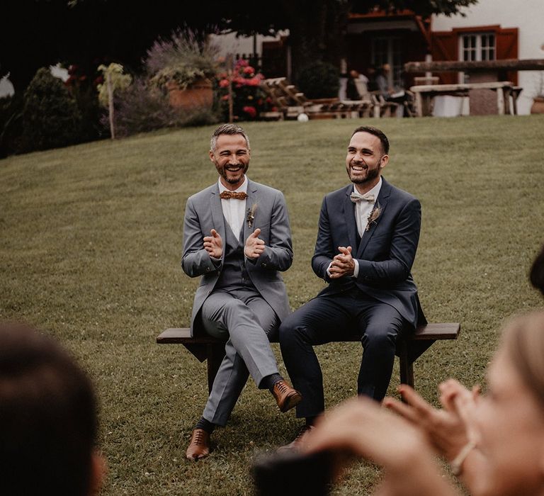 Grooms bow ties and complementing suits