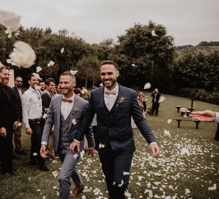 Confetti exit for grooms bow ties and wedding suits