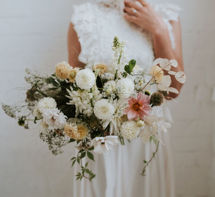 delicate wedding bouquet with white dahlias, stocks and foliage