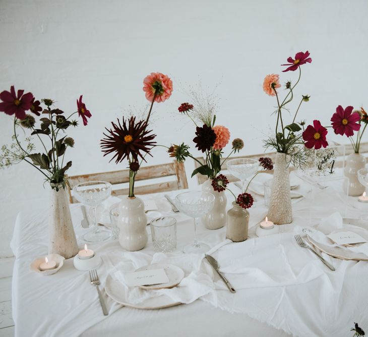 all white wedding table decor with colourful wedding flowers