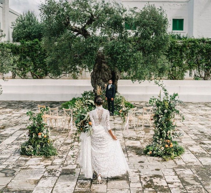 First Look with Bride in Lace Andrea Sedici Wedding Dress and Groom in Navy Suit