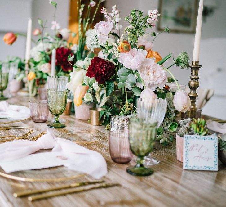 Wedding Reception Table Decor with Glass Charger Plate, Gold Cutlery, Candlesticks and Floral Centrepieces