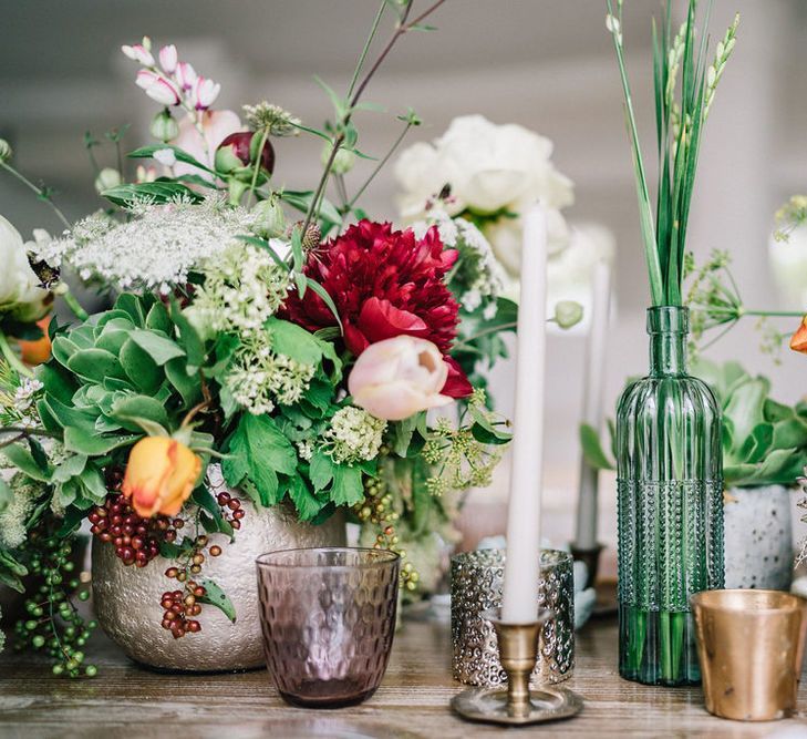 Colourful Wedding Flowers in Ceramic Vases with Candles