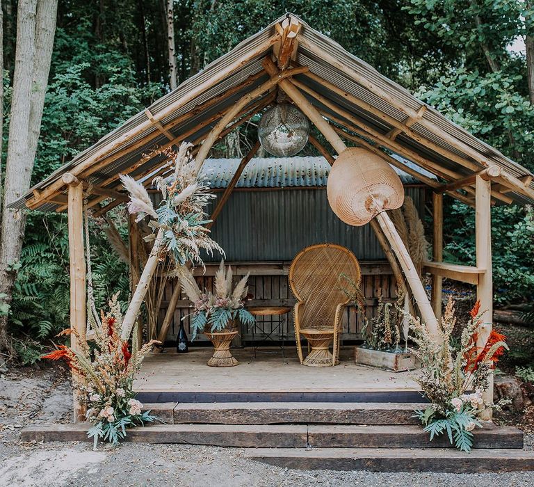 Wooden Altar at Wilderness Weddings with Natural Flower Arrangements