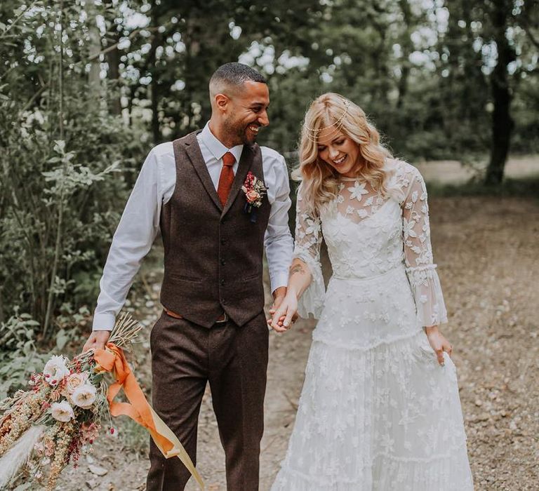 Boho Bride and Groom Holding Hands in the Woodland