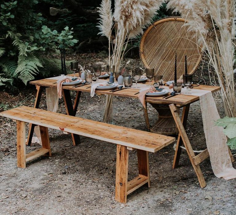 Outdoor Tablescape with Wooden Bench, Peacock Chair and Pampas Grass Flowers