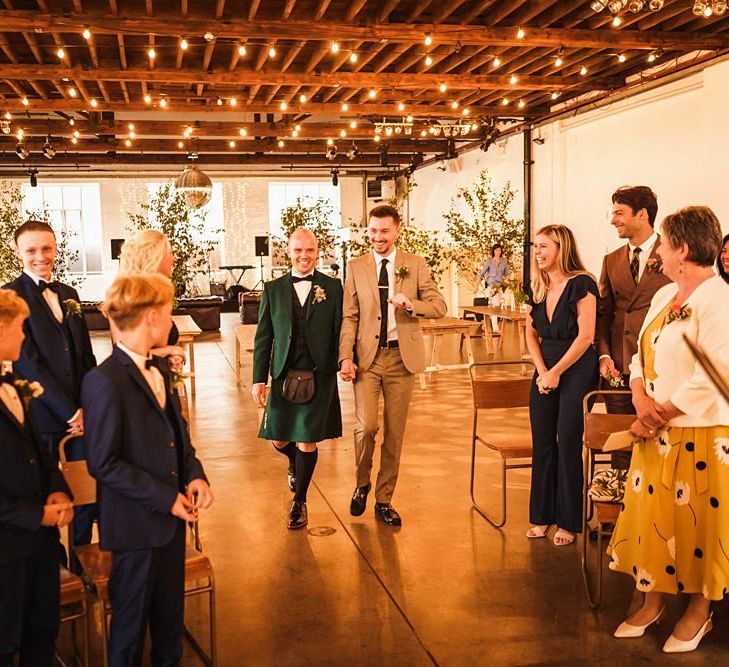 Grooms walk down the aisle together