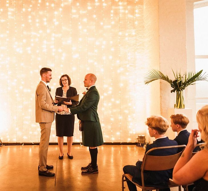 Fairy light backdrop for same-sex wedding at  Trinity Buoy Wharf