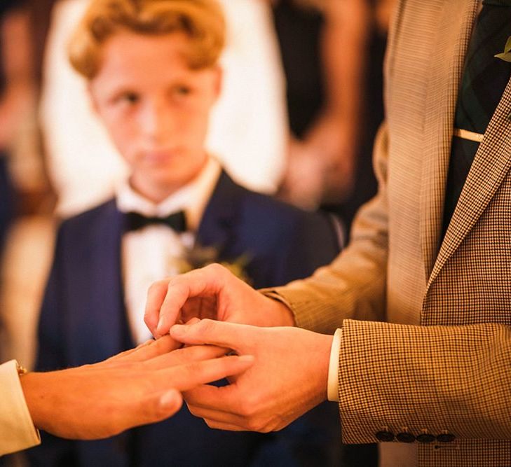 Grooms exchange rings at  Trinity Buoy Wharf wedding