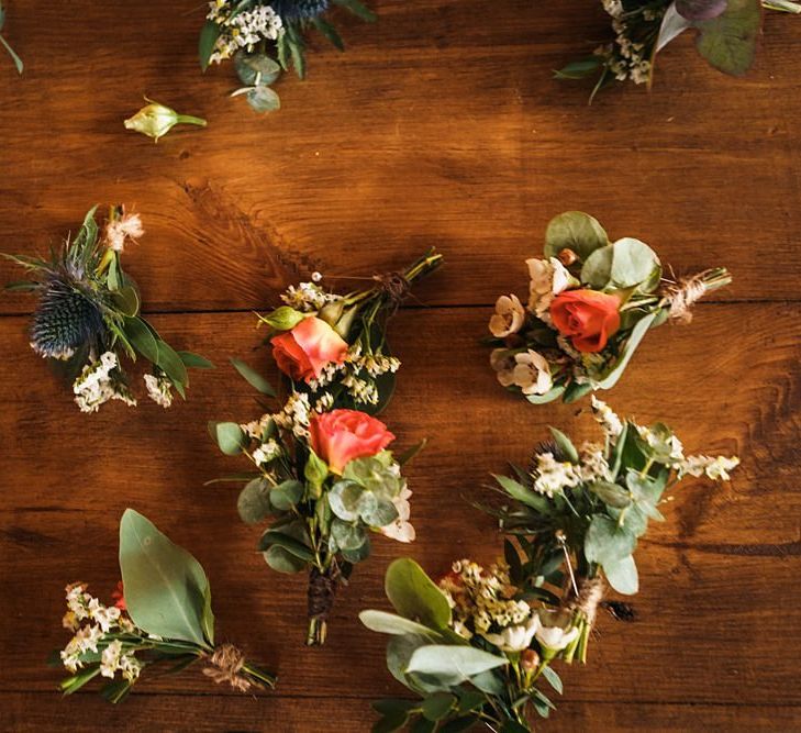 Orange buttonholes for grooms and wedding party