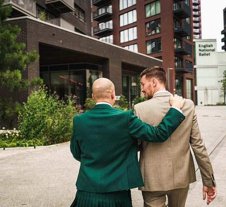 Groom in green wedding suit with his new husband