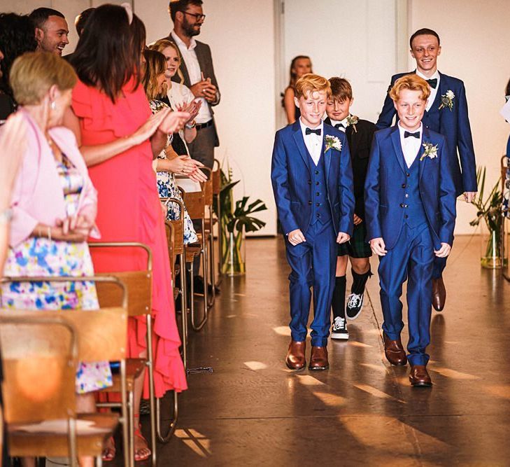 Page boys walk down the aisle at  Trinity Buoy Wharf