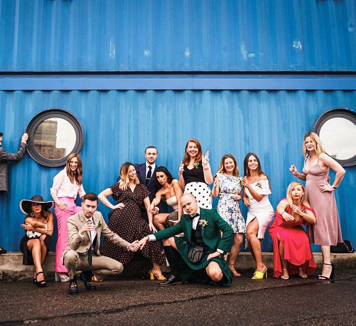 Grooms pose with guests at  Trinity Buoy Wharf wedding