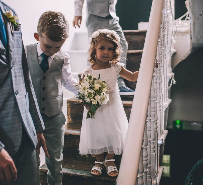 Young wedding guest with white bouquet at same-sex city celebration