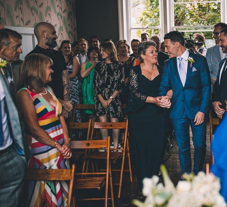 Groom walking down the aisle at The Roost Dalston Wedding Reception with vintage decor