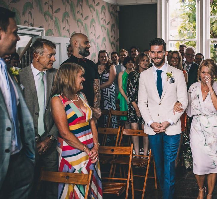 Groom walking down the aisle at The Roost Dalston Wedding Reception with vintage decor