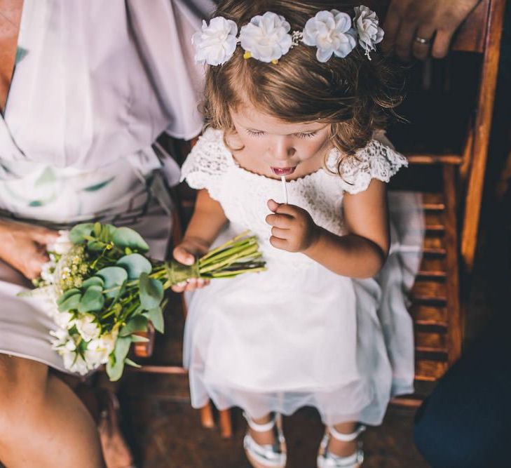 Young wedding guest with white bouquet at same-sex city celebration