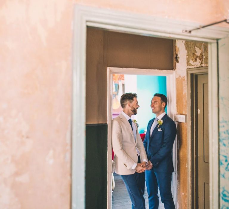 The Roost Dalston gay wedding with vintage decor and groom wearing a white blazer