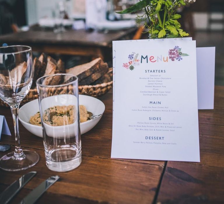 Personalised colourful menu at intimate city reception with vintage decor and eclectic touches