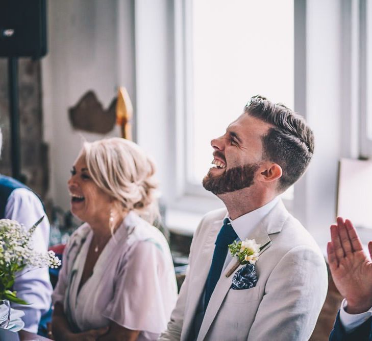 Grooms enjoying the speeches at same-sex intimate celebration in London