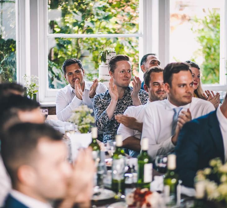 Guests enjoying the reception at same-sex intimate celebration in London with vintage decor and colourful styling