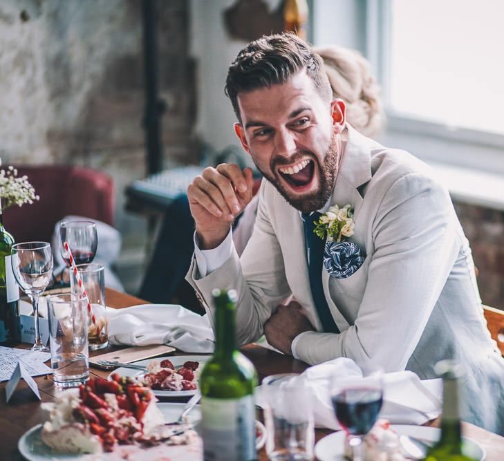 Grooms enjoying the speeches at same-sex intimate celebration in London