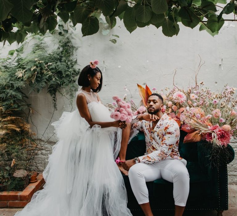 Bride in tulle wedding dress and groom floral shirt at tropical wedding inspiration