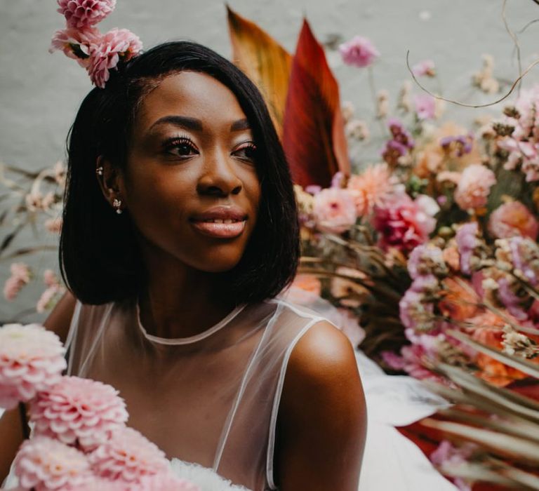 Beautiful bride with bob sat amongst the flowers