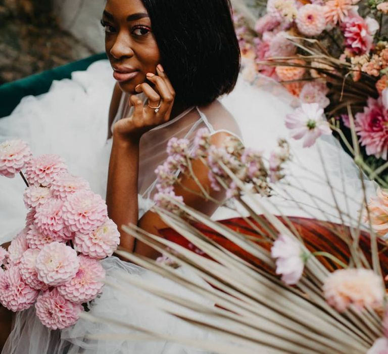 Beautiful bride sitting amongst the flowers