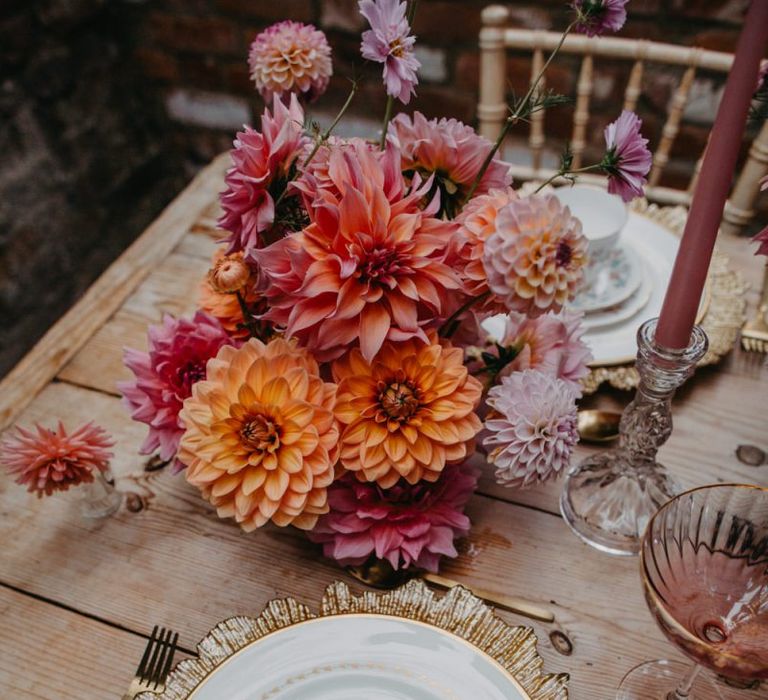 Place setting with gold charger plate and tassel stationery