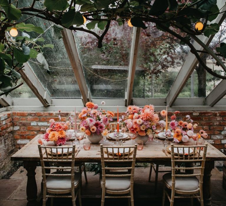 Intimate wedding reception table with floral centrepieces at Secret Garden Kent