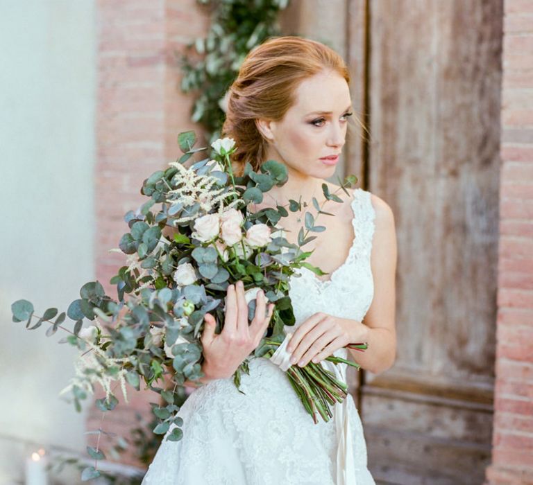 Bride in Lace Sorrisi di Gioia Wedding Dress Holding in a Eucalyptus  &amp; Pink Rose Bouquet