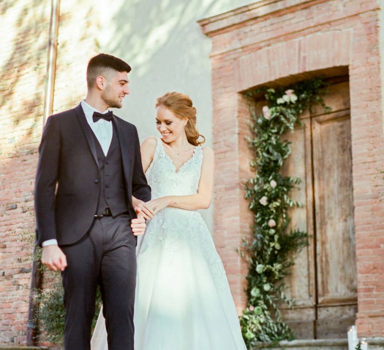 Bride in Lace Sorrisi di Gioia Wedding Dress and Groom in Black Tie Suit