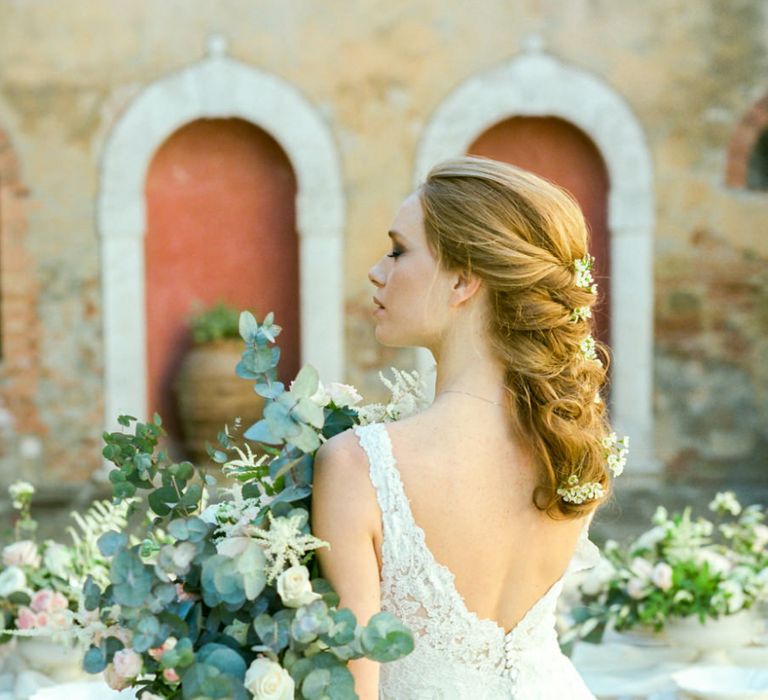 Bride in Lace Sorrisi di Gioia Wedding Dress with V Back and Braided Hairstyle