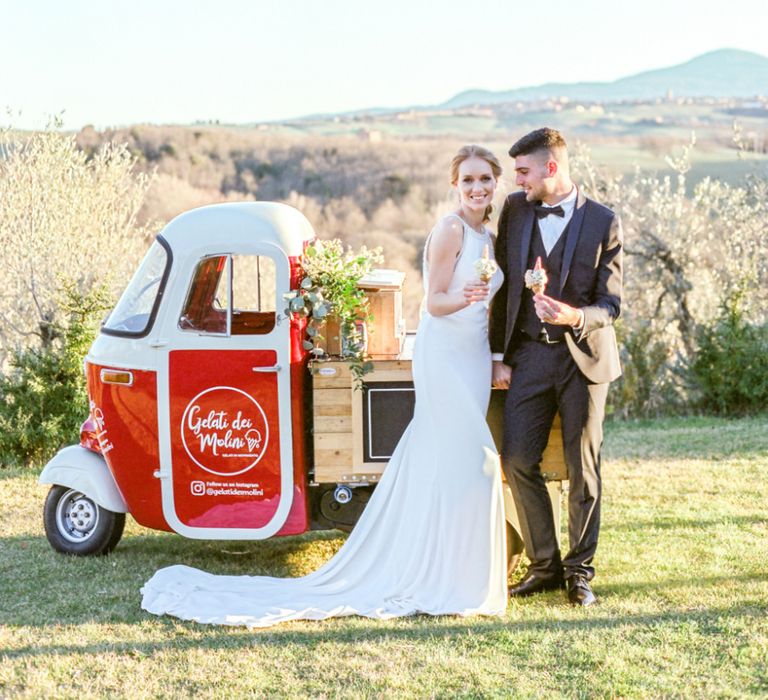 Bride in Lace Wedding Dress and Groom in Tuxedo Getting Ice-cream at a Gelato Truck