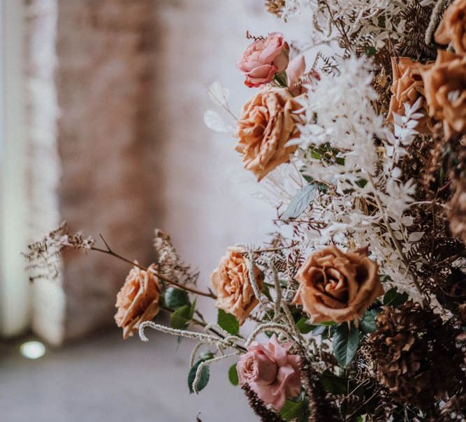 Orange and white wedding floral arrangement