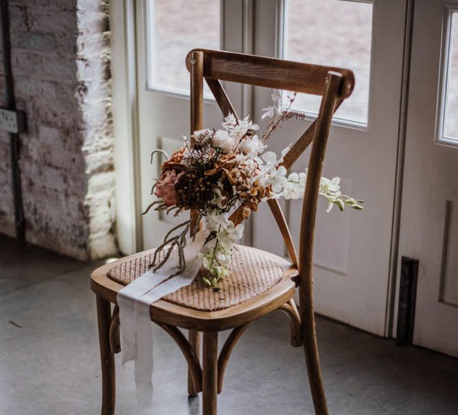 Orange and white hand tied wedding bouquet at Iscoyd Park Coach House