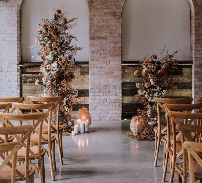 Wedding ceremony at Iscoyd Park Coachhouse with orange vertical flower display