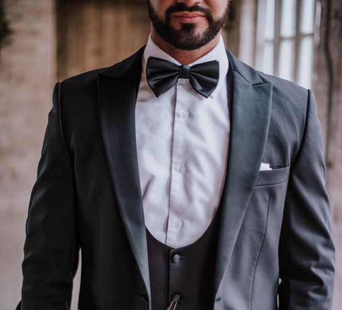 Groom in lounge suit with horse shoe waistcoat at Iscoyd Park