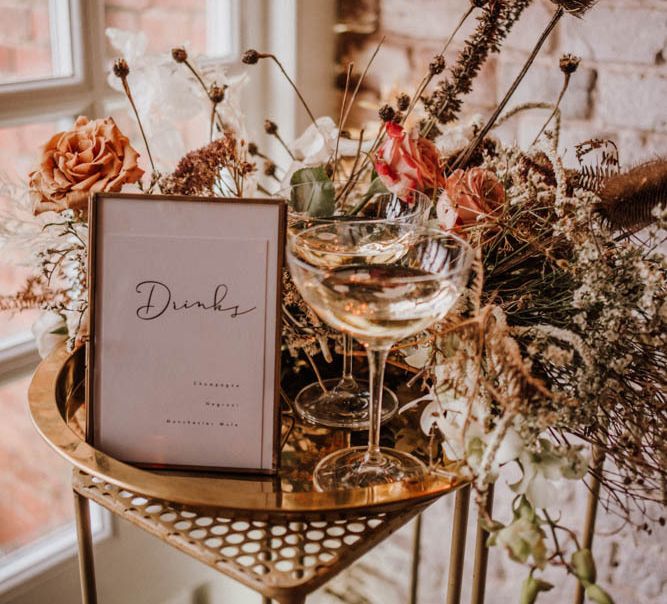 Gold platter drinks stand and champagne coupe glass at Iscoyd Park Coach House