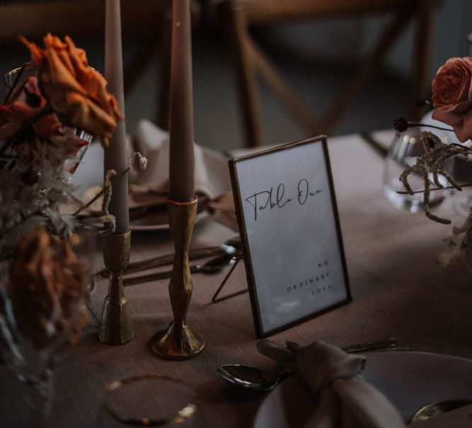 Coloured taper candles in gold candlesticks at Iscoyd Park Coach House