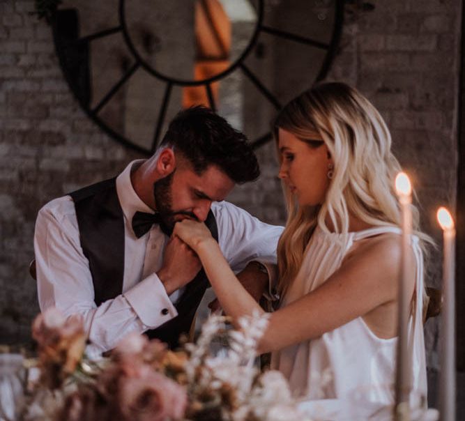 Groom kissing his brides hand at romantic, Iscoyd Park, wedding reception