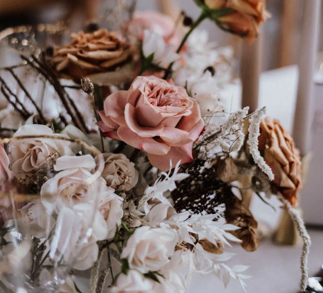 white, pink and orange wedding flower centrepiece