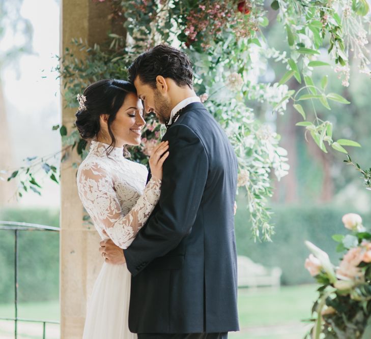 Bride in Lace Long Sleeved Suzanne Neville Wedding Dress | Groom in Traditional Morning Suit | Blush &amp; Burgundy Floral Fairytale Wedding Inspiration at Grittleton House Planned &amp; Styled by Jennifer Louise Weddings | Katherine Yiannaki Photography